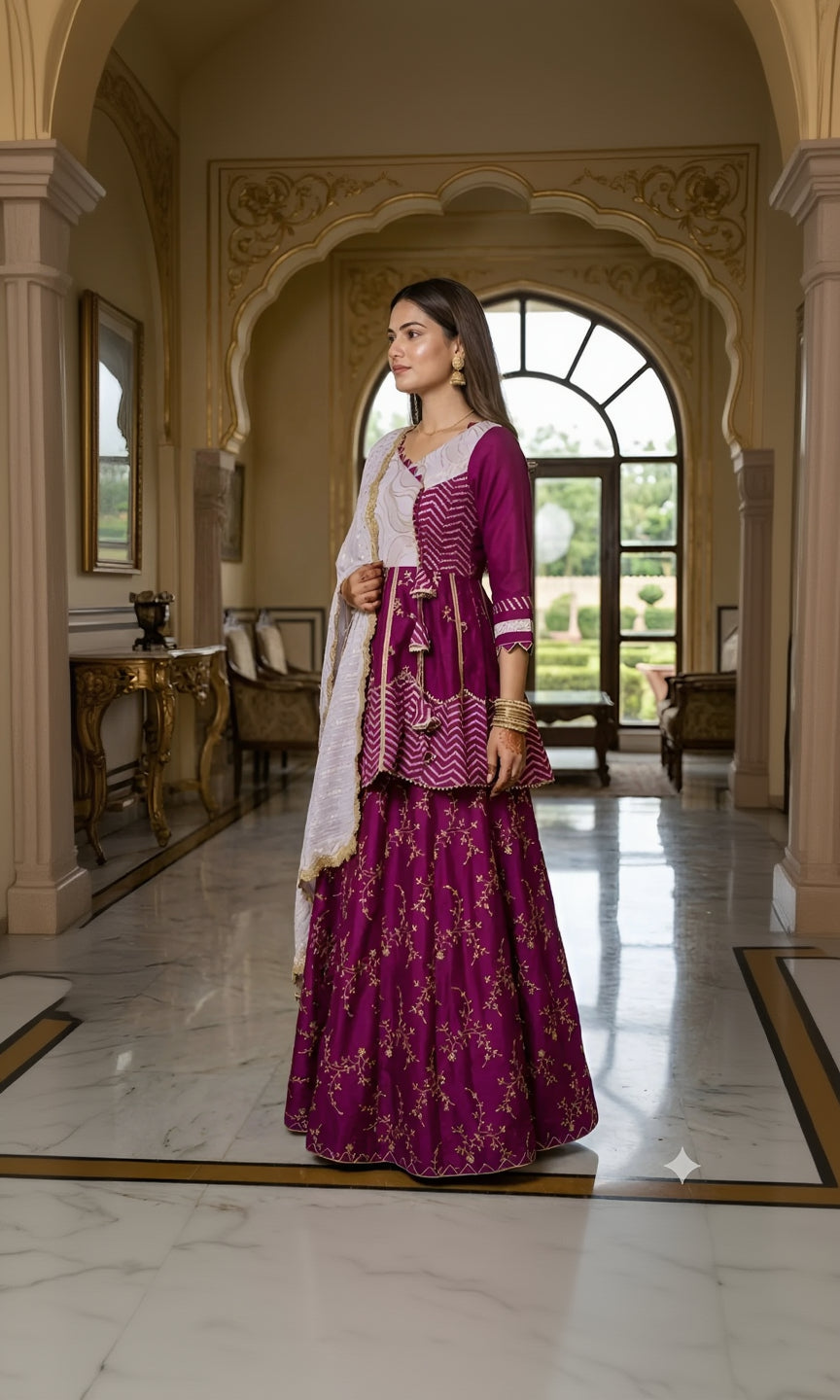 Woman in a traditional purple and white outfit standing in an elegant interior setting.