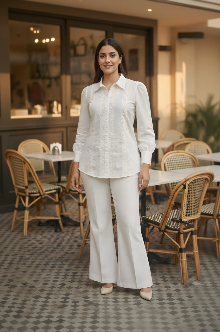 Woman in a white outfit standing in an outdoor cafe setting