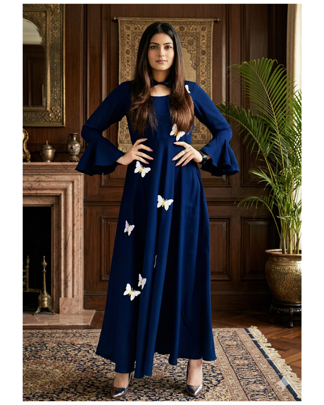 Woman wearing a blue dress with white butterfly patterns in an elegant room.