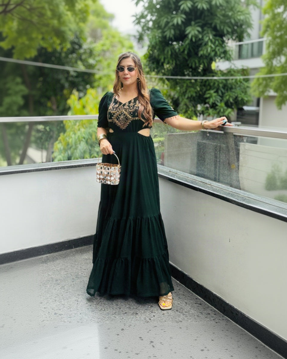 Woman in a green dress standing on a balcony with trees in the background