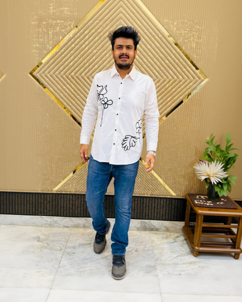 Man standing in front of a decorative wall with geometric patterns