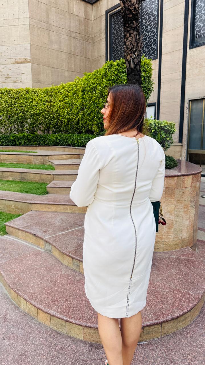 Woman in a white dress standing on steps outdoors