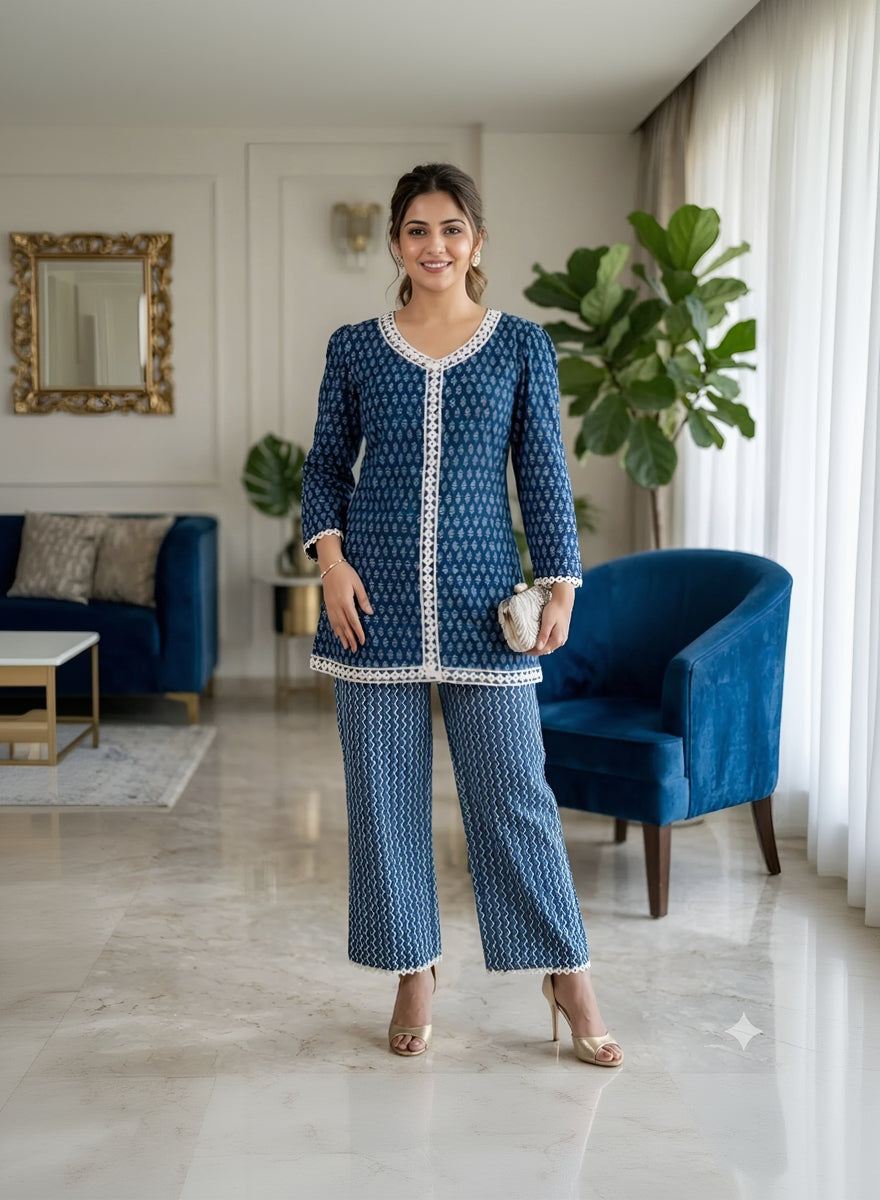 Woman wearing a blue patterned outfit in a living room setting