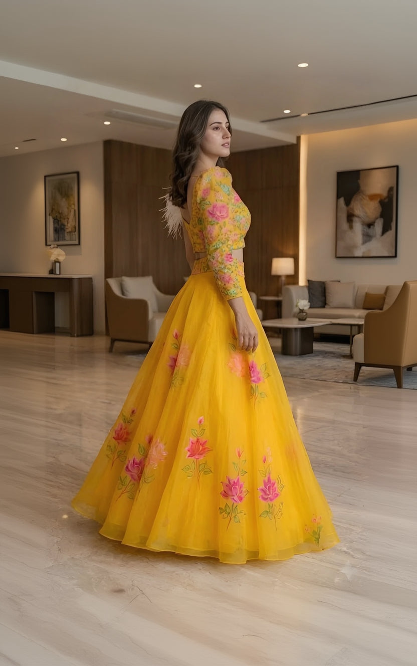 Woman in a yellow floral outfit standing in an indoor setting