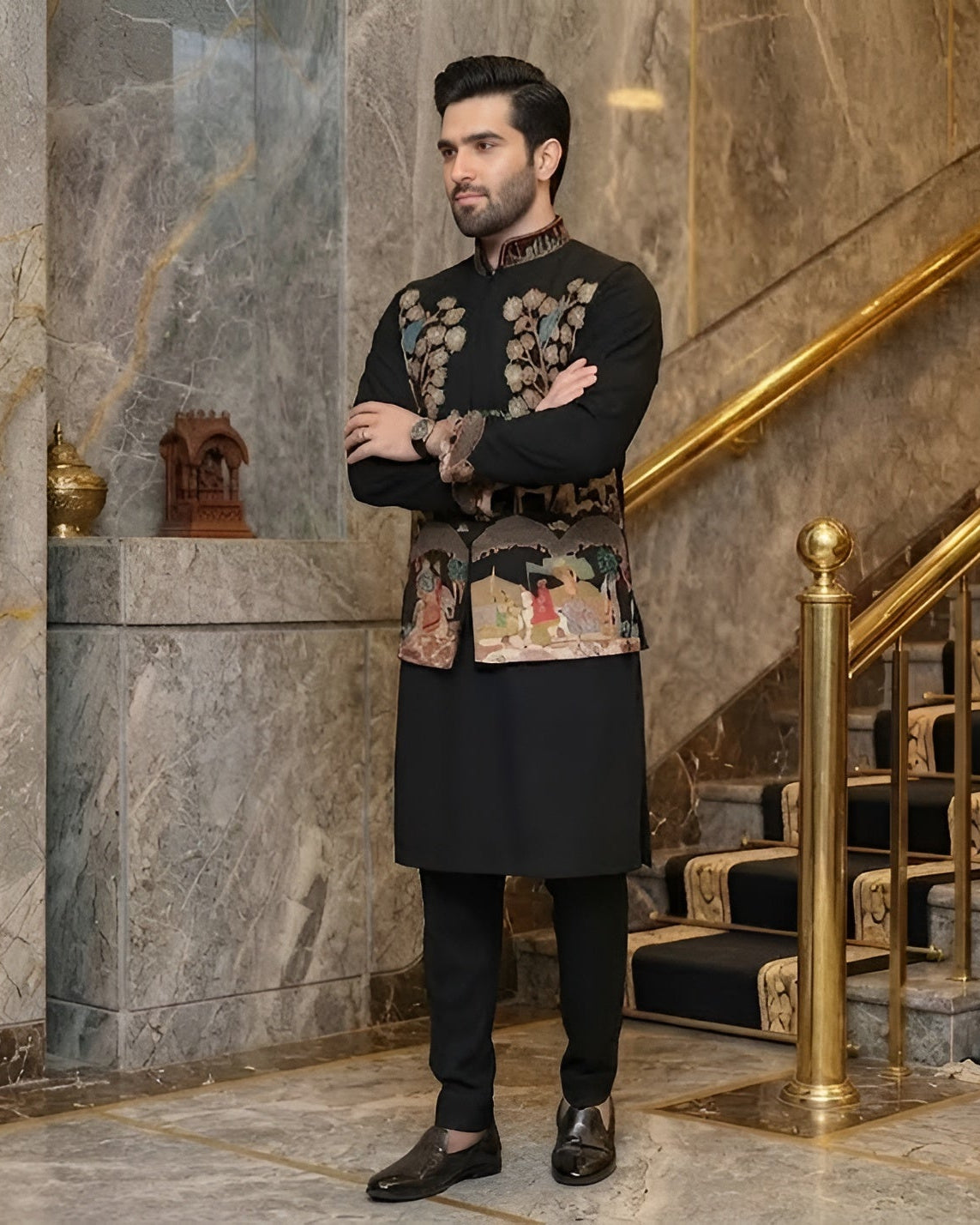 Man in formal attire standing in a luxurious interior setting with marble walls and gold accents.